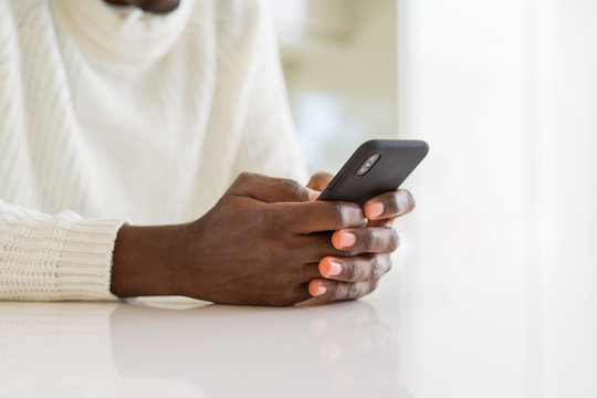Close up of african man hands using smarpthone
