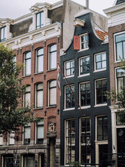 Obraz premium The typical elongated, crooked and charming rows of houses in Amsterdam.
