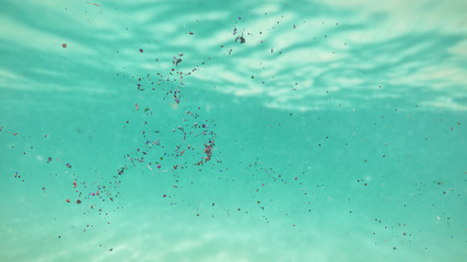 plastic pollution, micro plastic particle and nurdles in ocean water - obrazy, fototapety, plakaty