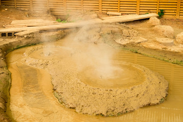 Kamado Jigoku pond onsen Beppu ,focus to circle bubbles forming in yellow mud the pond, which is one of the famous natural hot springs viewpoint, representing the various hells in Beppu.  