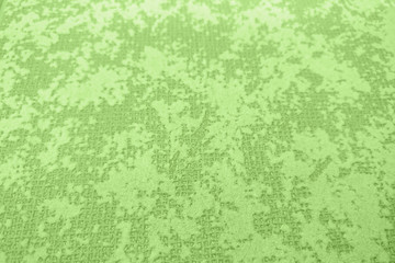 Texture inhomogeneously painted light green wall background