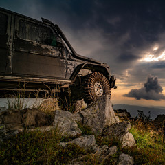 Car brakes with absorbers. Car tire. Off-road travel on mountain road. Mud and water splash in...