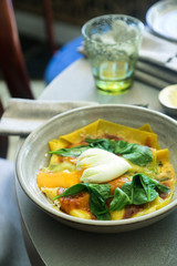 Homemade pasta with poached egg and spinach