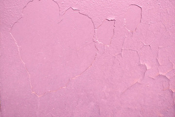 The background of dried paint on the metal in the form of a heart. Pink texture dirty wall in Valentine's day, copy space