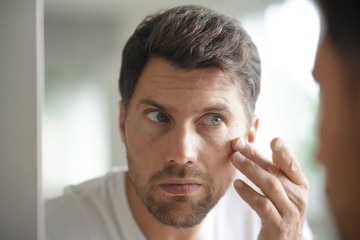 Portrait of a man in front of mirror