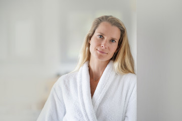 Blond woman wearing white bathrobe