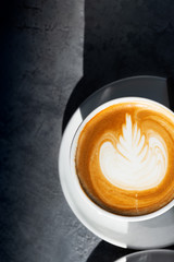Flat white coffee on the table in the cafe