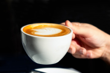 Flat white coffee on the table in the cafe