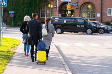 Family walking in town with luggage