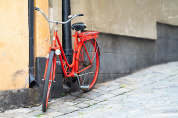 Bright red bicycle parked in an urban street