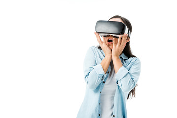 shocked woman in denim shirt with virtual reality headset isolated on white