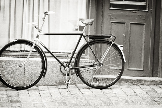 Greyscale image of a bicycle in a street