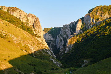 Turda gorge (Cheile Turzii), a location for hiking, climbing, via ferrata in Romania - view of the northern entrance from Petrestii de Jos, at sunset.