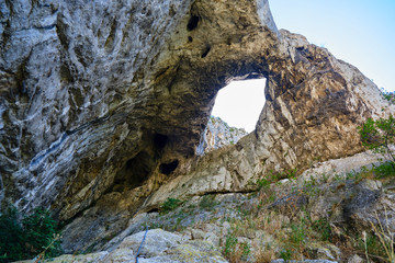 Hili cave in Turda gorge (Cheile Turzii) Romania, as seen from the via ferrata route that goes through it. Adventure concept.