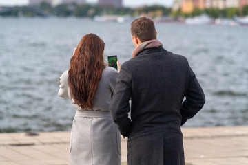 Young couple checking a photograph on their mobile