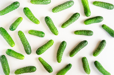 Flat lay of raw fresh cucumbers on white background. Top view. Vegetarian, vegan, organic food and alkaline meal concept