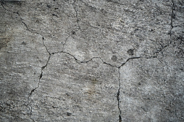 Obraz na płótnie Canvas Texture of an old cracked concrete wall. Background image of a worn gray concrete surface