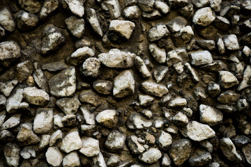Texture photo of rough concrete plaster with sprinkled gravel