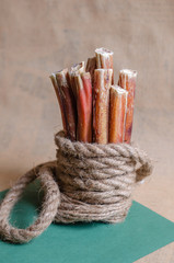 Close-up of dried bully sticks for domestic dogs. Natural chewing treats are wrapped with hemp...