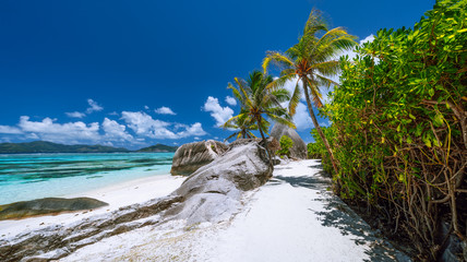 Anse Source d'Argent. Exotic tropical paradise beach on island La Digue in Seychelles. Blue ocean and sky, palm trees and sandy beaches