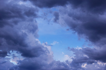Naklejka na ściany i meble Epic Storm clouds against blue sky background texture