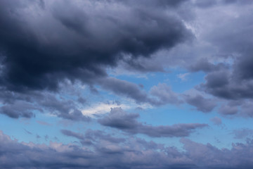 Epic Storm grey clouds against blue sky background texture