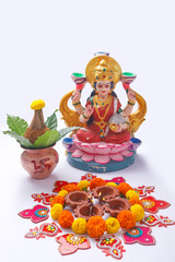Indian Festival Diwali , Laxmi Pooja with Copper Kalash, coconut flower rangoli on white background