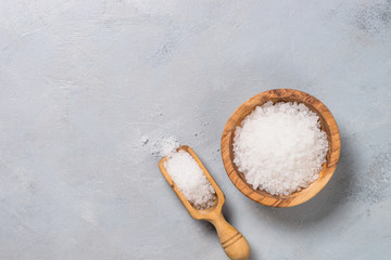 Sea salt on gray stone background.