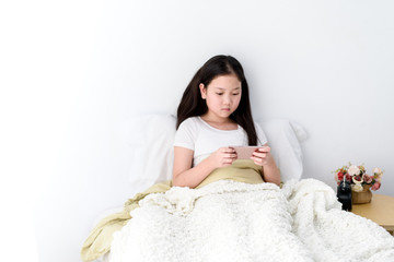 Young Asian girl play a smartphone