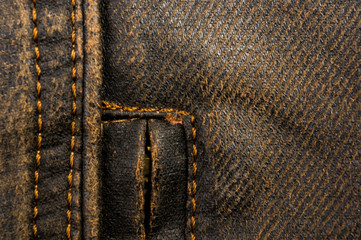 clothing items stonewashed cotton fabric texture with seams, clasps, buttons and rivets, macro