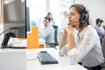 Professional helpline call center agent operator woman wearing headset working in customer care...