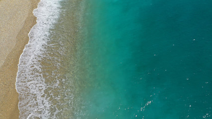 Aerial drone top down photo of tropical exotic sandy bay with emerald sea and waves