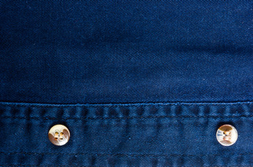 clothing items stonewashed cotton fabric texture with seams, clasps, buttons and rivets, macro