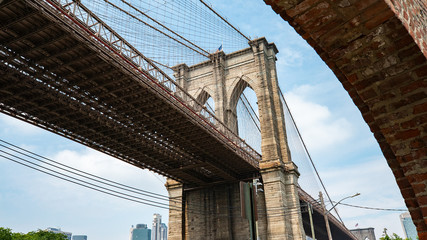 Lower view of Brooklyn bridge in New York City at day