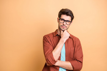 Close-up portrait of his he nice attractive serious focused minded brown-haired guy experienced professional financier economist thinking touching chin isolated over beige color pastel background