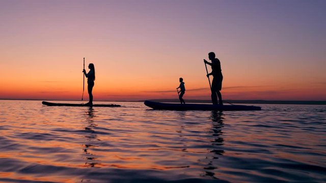 Girl and boys supping on water in the evening.