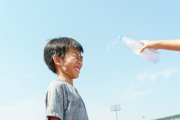 Young boy get a water drop
