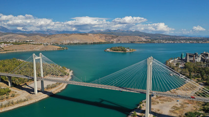 Aerial drone photo of famous new suspension bridge of halkida or Chalkida connecting mainland Greece with Evia island with beautiful clouds and blue sky, Greece
