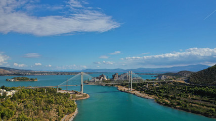 Naklejka premium Aerial drone photo of famous new suspension bridge of halkida or Chalkida connecting mainland Greece with Evia island with beautiful clouds and blue sky, Greece