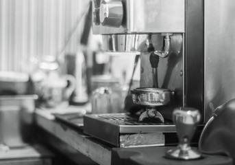 Making coffee concept. Black and white close up detail with modern cafe machine.