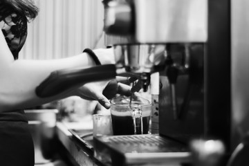 Making coffee concept. Black and white close up detail with modern cafe machine.