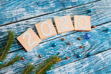 wooden cubes for your new year dates top view new year concept blue wooden background fir branch