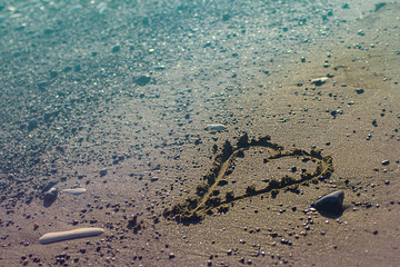Heart on the sand beach. Conceptual design about relations, love and travelling, romantic holiday, honey moon. Pink and blue duotone. St.Valentine's day on sea. Horizontal with copy space
