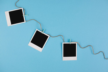 Instant photo frames on a blue background. Concept of preservation of memories. Flat lay.