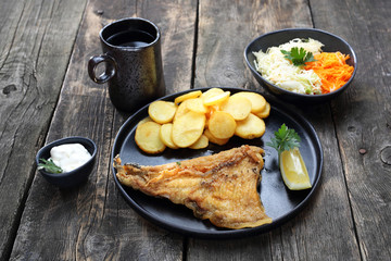 Fish and chips and salad. Dinner meal