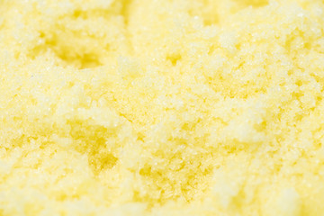 Yellow sugar scrub with the smell of lemon for the depilation process on a white background