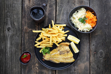 Fried fish fillet tomato chips and salad. Dinner meal. Top view