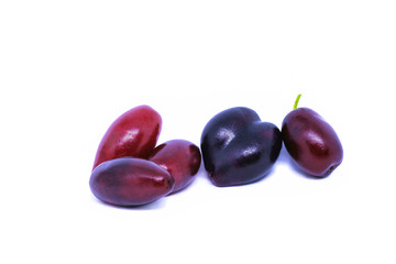 Cornus mas or Cornelian cherry fruit isolated on white background