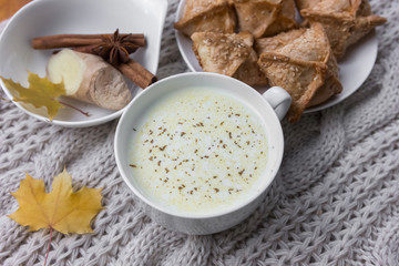  knitted sweater background gray milk with spices in a mug autumn leaves spices ginger cold