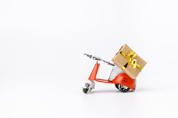 Miniature toy red and white retro scooter with gift  on white background. Metal model.